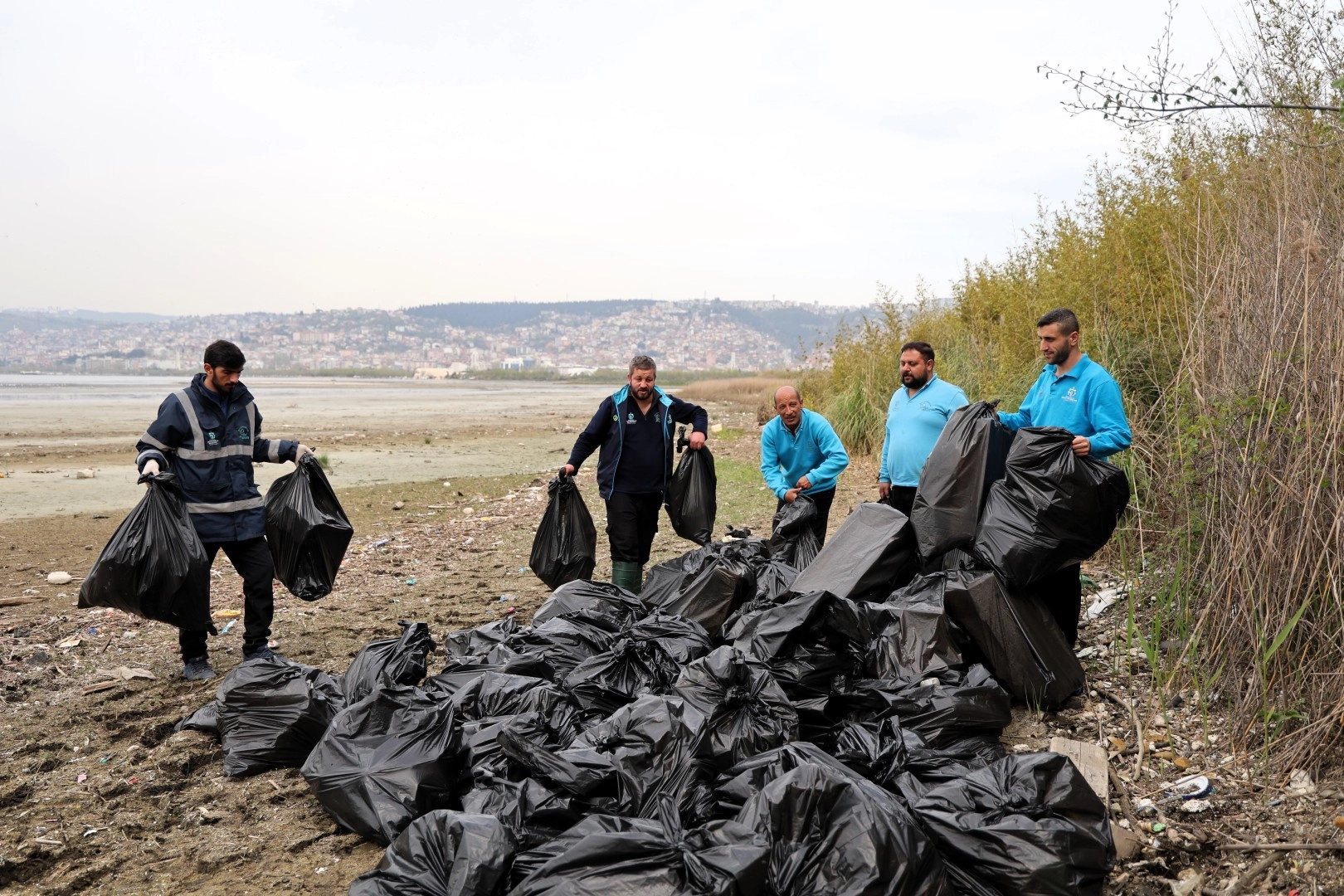 Kocaeli'de Mavi Takım ekipleri tarafından sahil temizliği yapılıyor ve toplanan atıklar gösteriliyor.